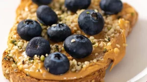 slice of whole-grain toast with creamy peanut butter and fresh blueberries